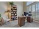 Bright office featuring a built-in bookcase, a large window with shutters, and a neutral color palette at 12344 Turquoise Terrace St, Castle Pines, CO 80108