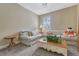 Cozy sitting room with plush seating and a decorative coffee table is filled with natural light at 12344 Turquoise Terrace St, Castle Pines, CO 80108