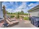 Backyard patio with lounge chairs, landscaping, and outdoor grill at 1011 S Valentia St # 30, Denver, CO 80247