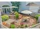 Landscaped backyard patio with lounge chairs, outdoor dining area, and garden at 1011 S Valentia St # 30, Denver, CO 80247