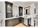 Stylish bar area featuring custom cabinetry, a wine cooler, and elegant countertops at 1011 S Valentia St # 30, Denver, CO 80247