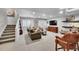 Basement with staircase, seating area, game table, TV and shelving at 1011 S Valentia St # 30, Denver, CO 80247