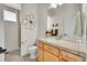 Well-lit bathroom with a neutral color palette, vanity with a large mirror, and walk-in shower at 1011 S Valentia St # 30, Denver, CO 80247