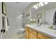 Well-lit bathroom featuring vanity, mirror, and shower with glass door at 1011 S Valentia St # 30, Denver, CO 80247