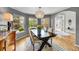 Bright dining room featuring a wood table, chandelier, and large windows offering scenic views at 1011 S Valentia St # 30, Denver, CO 80247