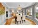 Elegant dining room with a chandelier, dining table, and natural light from the bay windows at 1011 S Valentia St # 30, Denver, CO 80247