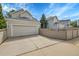 Home exterior featuring a spacious garage, driveway, and neat landscaping at 1011 S Valentia St # 30, Denver, CO 80247