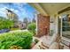 Charming front porch with cozy seating, decorative plants and brick accents enhancing curb appeal at 1011 S Valentia St # 30, Denver, CO 80247