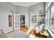 Bright home office with built-in shelves, hardwood floors, and a comfortable seating area at 1011 S Valentia St # 30, Denver, CO 80247