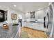 Well-lit kitchen featuring white cabinets, stainless appliances, and direct laundry access at 1011 S Valentia St # 30, Denver, CO 80247