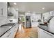 Modern kitchen boasting white cabinets, stainless steel appliances, and hardwood floors at 1011 S Valentia St # 30, Denver, CO 80247