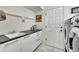 Convenient laundry area featuring a sink, white cabinetry, and a sleek countertop, perfect for managing household tasks at 1011 S Valentia St # 30, Denver, CO 80247