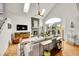 Living room with a stone fireplace, skylights, wood floors, and vaulted ceilings at 1011 S Valentia St # 30, Denver, CO 80247