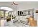 Open-concept living area with vaulted ceilings, hardwood floors, and a view of the kitchen at 1011 S Valentia St # 30, Denver, CO 80247