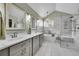 Luxurious main bathroom with a standalone tub, marble countertops, glass-enclosed shower, and stylish lighting at 1011 S Valentia St # 30, Denver, CO 80247