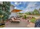 Landscaped patio featuring comfortable lounge chairs, shade umbrella, and lovely garden at 1011 S Valentia St # 30, Denver, CO 80247