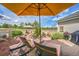 Cozy patio with lounge seating, an umbrella, and a beautiful garden backdrop at 1011 S Valentia St # 30, Denver, CO 80247