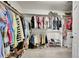 Spacious walk-in closet with dual-level hanging rods, ample shoe storage, and well-organized shelving at 1011 S Valentia St # 30, Denver, CO 80247