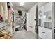 Well-organized walk-in closet with multiple hanging rods, shelves, and storage solutions for optimal organization at 1011 S Valentia St # 30, Denver, CO 80247