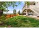 Large backyard featuring lush lawn, mature trees, and privacy fence at 5745 S Andes St, Aurora, CO 80015