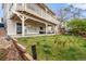Spacious backyard featuring a covered patio, lush lawn, and mature trees at 5745 S Andes St, Aurora, CO 80015