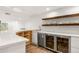 Modern bar area with custom shelving, sleek countertops, and stainless steel appliances at 5745 S Andes St, Aurora, CO 80015