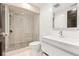 Updated bathroom featuring a walk-in shower with river rock floor and modern vanity at 5745 S Andes St, Aurora, CO 80015