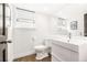 Modern bathroom with sleek white vanity and fixtures and a minimalist aesthetic at 5745 S Andes St, Aurora, CO 80015