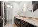 Bathroom features dual sinks with granite countertops and decorative mirrors at 5745 S Andes St, Aurora, CO 80015