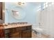 Bright bathroom with a granite countertop vanity and shower-tub combo at 5745 S Andes St, Aurora, CO 80015