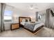 Bright bedroom with a modern ceiling fan, bedside tables, and windows offering a pleasant view at 5745 S Andes St, Aurora, CO 80015