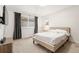 Well-lit bedroom with cozy decor, a modern platform bed, and a view from the window at 5745 S Andes St, Aurora, CO 80015