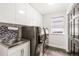 Well-equipped laundry room featuring a stainless steel sink, modern washer and dryer, storage cabinets, and tiled backsplash at 5745 S Andes St, Aurora, CO 80015