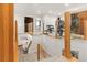 Loft area with glass railing overlooking the lower floor, featuring a home gym and access to other rooms at 5745 S Andes St, Aurora, CO 80015