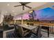 Inviting outdoor patio with dining set, fire pit table, and overhead lighting at 5745 S Andes St, Aurora, CO 80015