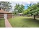 Grassy backyard featuring a shed, mature trees, and privacy fencing at 2526 W 39Th Ave, Denver, CO 80211