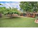 Expansive backyard with artificial turf, outdoor dining area, and mature trees at 2526 W 39Th Ave, Denver, CO 80211