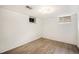 Clean basement area with wood laminate flooring and white painted walls at 2526 W 39Th Ave, Denver, CO 80211