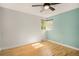 Cozy bedroom with hardwood floors, a ceiling fan, and a window overlooking the backyard at 2526 W 39Th Ave, Denver, CO 80211