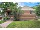 Brick house featuring mature landscaping, a walkway, and a well-kept lawn at 2526 W 39Th Ave, Denver, CO 80211
