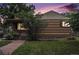 Charming brick home featuring a cozy front porch and a well-maintained lawn at 2526 W 39Th Ave, Denver, CO 80211