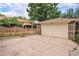 Detached garage with a brick exterior and a large driveway at 2526 W 39Th Ave, Denver, CO 80211