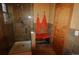 Walk-in shower with orange towels, seat and glass door at 308 Baron Ave, Lafayette, CO 80026