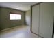 Bedroom features include neutral carpet, a window for natural light, and a built-in closet for storage at 308 Baron Ave, Lafayette, CO 80026