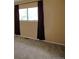 Bedroom with light tan carpet, tan walls and dark brown curtains at 308 Baron Ave, Lafayette, CO 80026