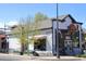 A classic building with American flag featuring The Collective Arts on Tap, an inviting facade at 308 Baron Ave, Lafayette, CO 80026