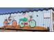 Lafayette, Colorado building featuring whimsical mural of people on bicycles and chickens, artful design at 308 Baron Ave, Lafayette, CO 80026