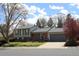 Charming two-story home featuring a well-maintained lawn and attached two car garage at 308 Baron Ave, Lafayette, CO 80026
