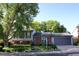 Charming home featuring brick and siding, a well-manicured lawn, beautiful foliage, and an attached two-car garage at 308 Baron Ave, Lafayette, CO 80026