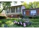 Charming home with a well-manicured lawn, mature shade tree and gorgeous flower beds at 308 Baron Ave, Lafayette, CO 80026